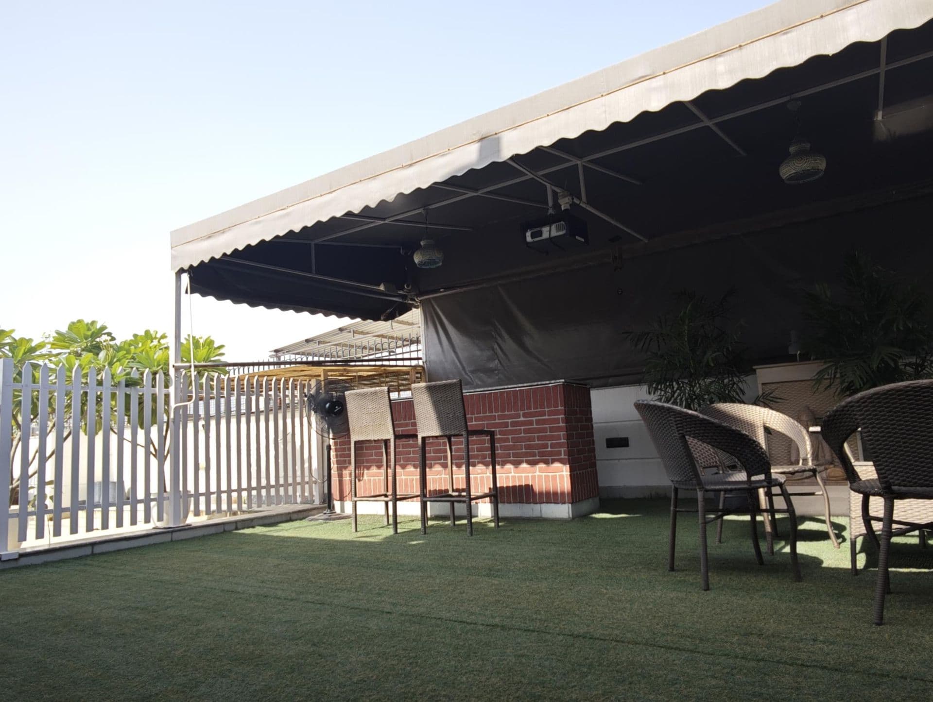 The bar, white picket fence and awning on the terrace