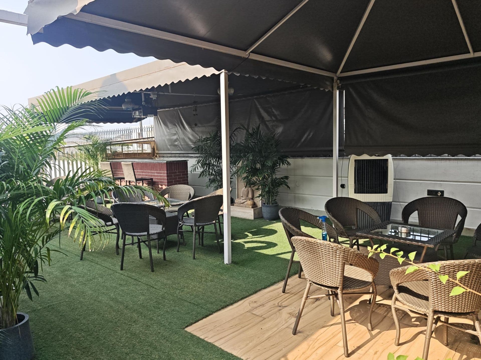 Book launches and readings at Terraza de Fiesta GK2: Lounge seating under the canopy, on green turf