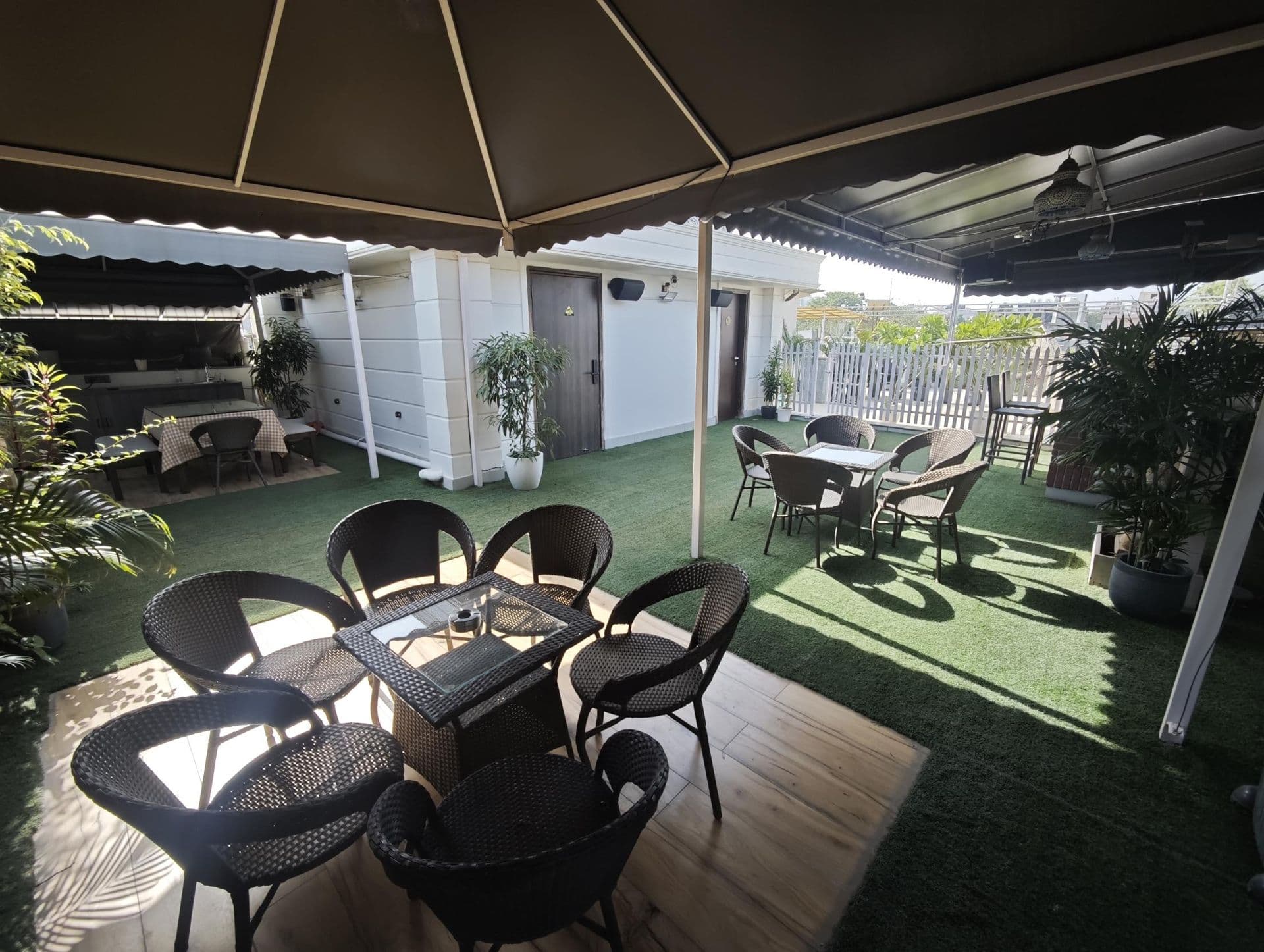 The terrace with speakers and the projector wall